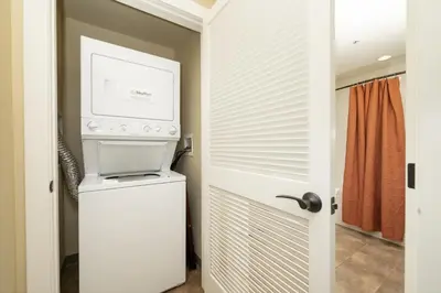 a kitchen with a washer and dryer next to a door at Base Camp 306 condo in Granby