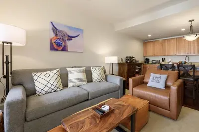 a living room with a couch and a table at Base Camp 304 condo in Granby