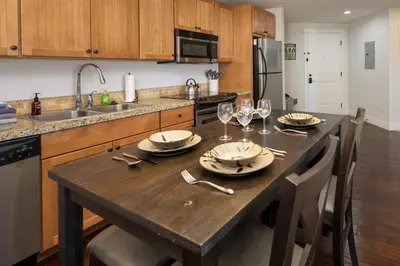 a kitchen with a wooden table with wine glasses at Base Camp 304 condo in Granby