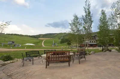 a group of benches sitting on a patio at Base Camp 304 condo in Granby
