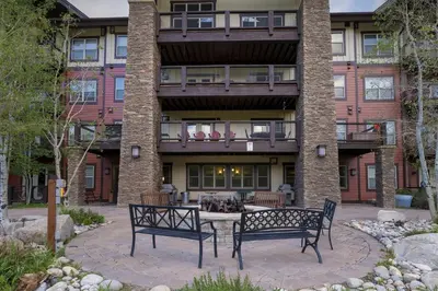 two benches sitting in front of a building at Base Camp 304 condo in Granby