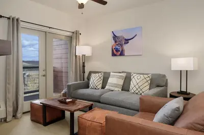 a living room with a couch and a table at Base Camp 304 condo in Granby
