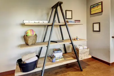 a ladder shelf in the corner of a room at Indian Trail Cabin cabin in Granby