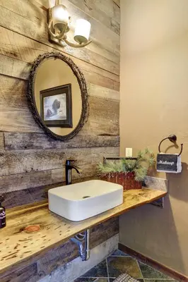 a bathroom with a white sink and a mirror at Indian Trail Cabin cabin in Granby