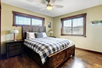 a bedroom with a bed and a ceiling fan at Indian Trail Cabin cabin in Granby