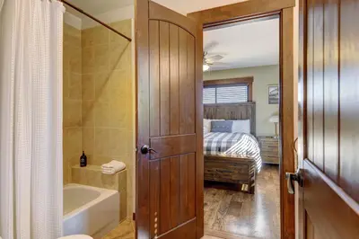 a bathroom with a tub and a bedroom with a bed at Indian Trail Cabin cabin in Granby
