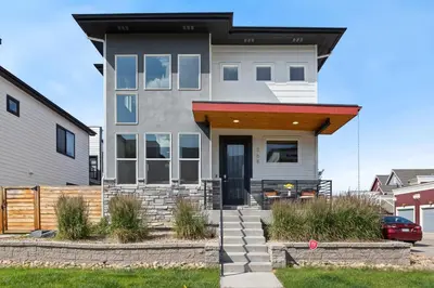 a house with an awning over the front door at Upbeat Retreat - Enjoy Bikes, Brews and Mtn Peaks! in Fort Collins