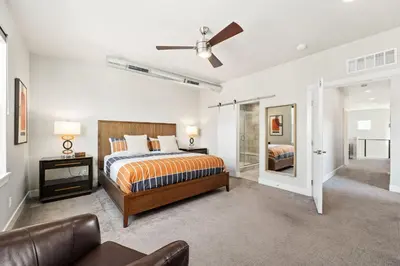 a large bedroom with a bed and a couch at Upbeat Retreat - Enjoy Bikes, Brews and Mtn Peaks! in Fort Collins