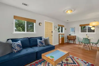 a living room with a blue couch and a table at Old Town Retreat w Vintage Flair Near CSU, Bikes! in Fort Collins