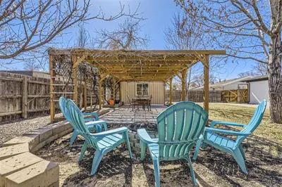 a group of blue chairs sitting in a yard at 15-mins from DIA, Fenced-Yard, Garage, Remodeled in Aurora
