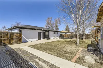 a house with a yard in front of a house at 15-mins from DIA, Fenced-Yard, Garage, Remodeled in Aurora