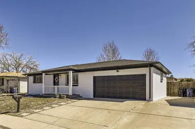 a white house with a garage at 15-mins from DIA, Fenced-Yard, Garage, Remodeled in Aurora