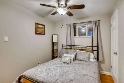 a bedroom with a bed with a ceiling fan at 1000 Dollar Rebate if You Buy A Home in Denver in Lakewood