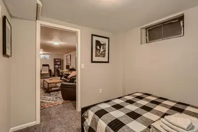 a bedroom with a bed and a living room at 1000 Dollar Rebate if You Buy A Home in Denver in Lakewood