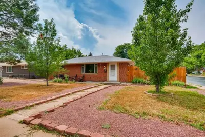 a small house with a tree in the yard at 1000 Dollar Rebate if You Buy A Home in Denver in Lakewood