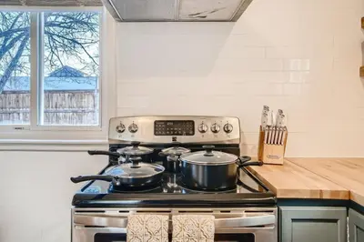 a stove with two pots on top of it in a kitchen at 1,000 Per Month Rebate When Buying A Home in Lakewood