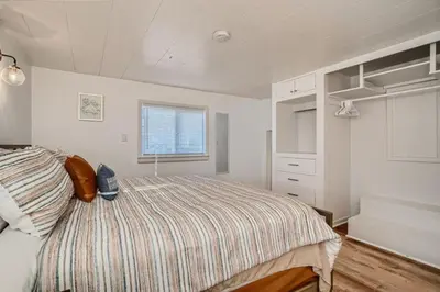a bedroom with a bed and a window at 1,000 Per Month Rebate When Buying A Home in Lakewood