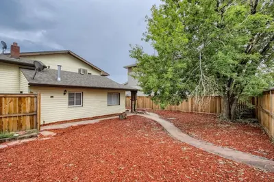 a home with a wooden fence and a yard at 1,000 Per Month Rebate When Buying A Home in Lakewood