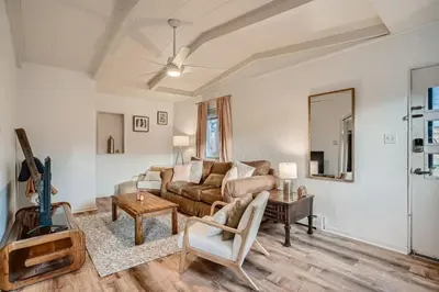 a living room with a couch and a table at 1,000 Per Month Rebate When Buying A Home in Lakewood