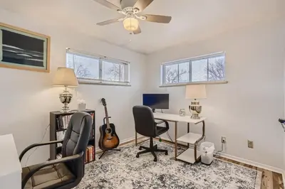 a home office with a desk and chairs and a fan at 1,000 Dollars For Each Month Stayed When Moving to Colorado in Arvada