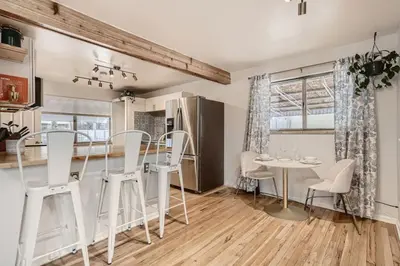 a kitchen and dining room with a table and chairs at 1,000 Dollars For Each Month Stayed When Moving to Colorado in Arvada