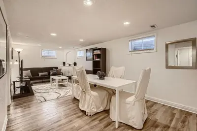 a living room with a white table and chairs at 1,000 Dollars For Each Month Stayed When Moving to Colorado in Arvada