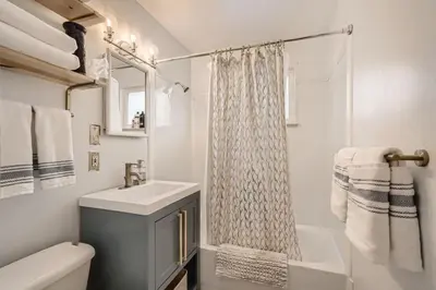 a white bathroom with a sink and a shower at 1,000 Dollars For Each Month Stayed When Moving to Colorado in Arvada