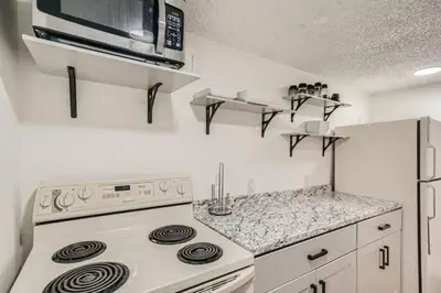 a kitchen with a stove and a microwave at 1,000 Dollars For Each Month Stayed When Moving to Colorado in Arvada