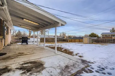 a covered patio with snow on the ground at 1,000 Dollars For Each Month Stayed When Moving to Colorado in Arvada