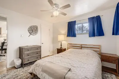 a bedroom with a bed and a ceiling fan at 1,000 Dollars For Each Month Stayed When Moving to Colorado in Arvada