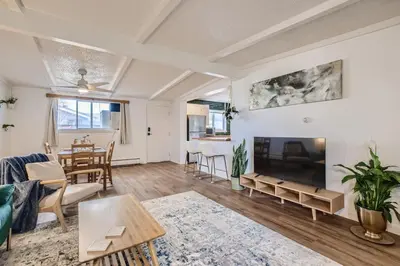 a living room with a large fireplace and a table at 1000 Dollar Rebate if You Buy A Home in Denver in Lakewood