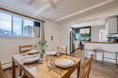 a dining room with a table and a kitchen at 1000 Dollar Rebate if You Buy A Home in Denver in Lakewood