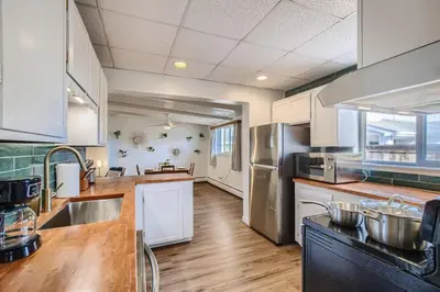 a kitchen with white cabinets and stainless steel appliances at 1000 Dollar Rebate if You Buy A Home in Denver in Lakewood