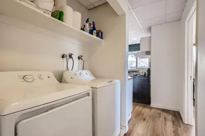 a white washer and dryer in a small kitchen at 1000 Dollar Rebate if You Buy A Home in Denver in Lakewood