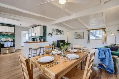 a dining room and living room with a table and chairs at 1000 Dollar Rebate if You Buy A Home in Denver in Lakewood