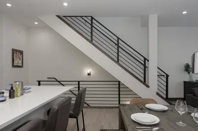 a dining room with a table and a staircase at 90 Hay Meadow townhouse in Fraser