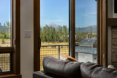 a couch in front of a window with a view at 90 Hay Meadow townhouse in Fraser