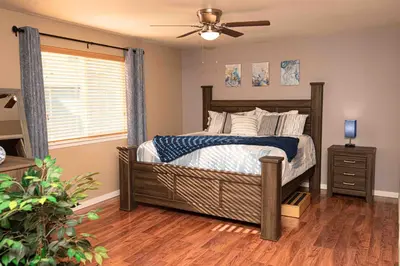 a bedroom with a bed and a ceiling fan at InHomeStays in Lakewood