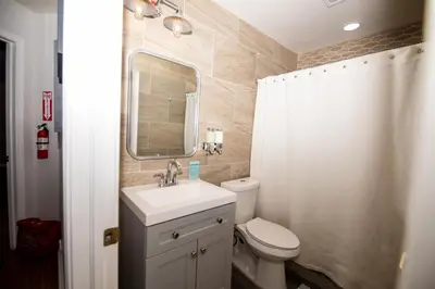 a bathroom with a sink and a toilet and a mirror at InHomeStays in Lakewood