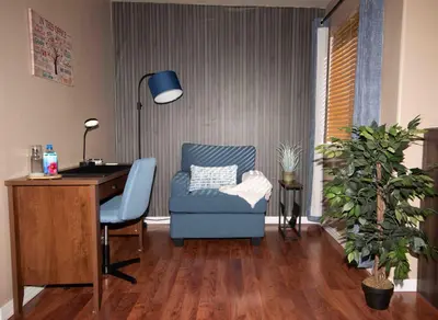 an office with a desk and a blue chair and a desk at InHomeStays in Lakewood