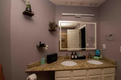 a bathroom with two sinks and a large mirror at InHomeStays in Lakewood
