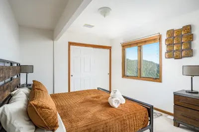 a bedroom with a bed with a stuffed animal on it at Mountain View Apartment Near Downtown & Trails in Evergreen