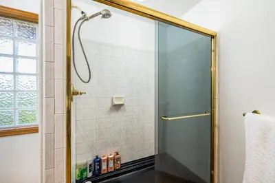a shower with a glass door in a bathroom at Mountain View Apartment Near Downtown & Trails in Evergreen