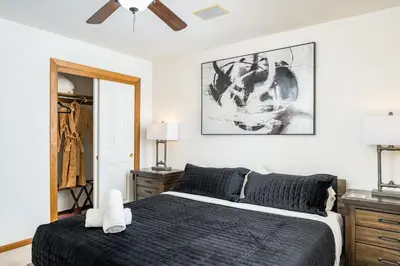a bedroom with a bed and a ceiling fan at Mountain View Apartment Near Downtown & Trails in Evergreen