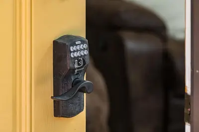 a metal door latch on a yellow door at Mountain View Apartment Near Downtown & Trails in Evergreen