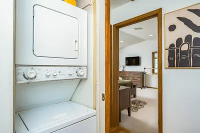 a kitchen with a washer and dryer in a room at Mountain View Apartment Near Downtown & Trails in Evergreen