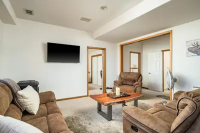 a living room with two couches and a table at Mountain View Apartment Near Downtown & Hiking in Evergreen