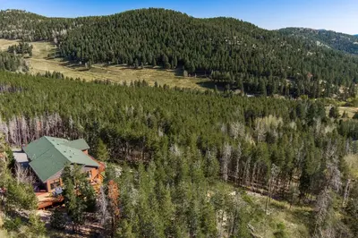 an aerial view of a house in the middle of a forest at Mountain View Apartment Near Downtown & Hiking in Evergreen