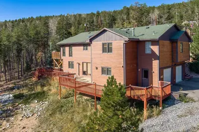 an aerial view of a house with a deck at Mountain View Apartment Near Downtown & Hiking in Evergreen