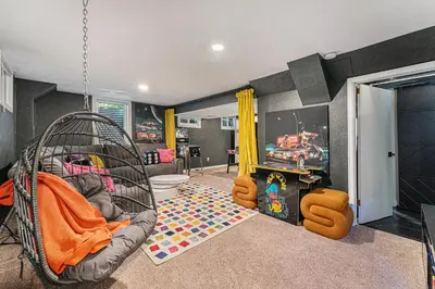 a childs room with a crib and a play area at All-In-One Retreat Spa, Gym, Fun Room & Location! in Arvada